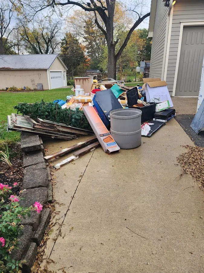 Dumpster being loaded with debris for Commercial Dumpster Rental in Bonham